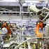 Industrial manufacturing facility with safety workers